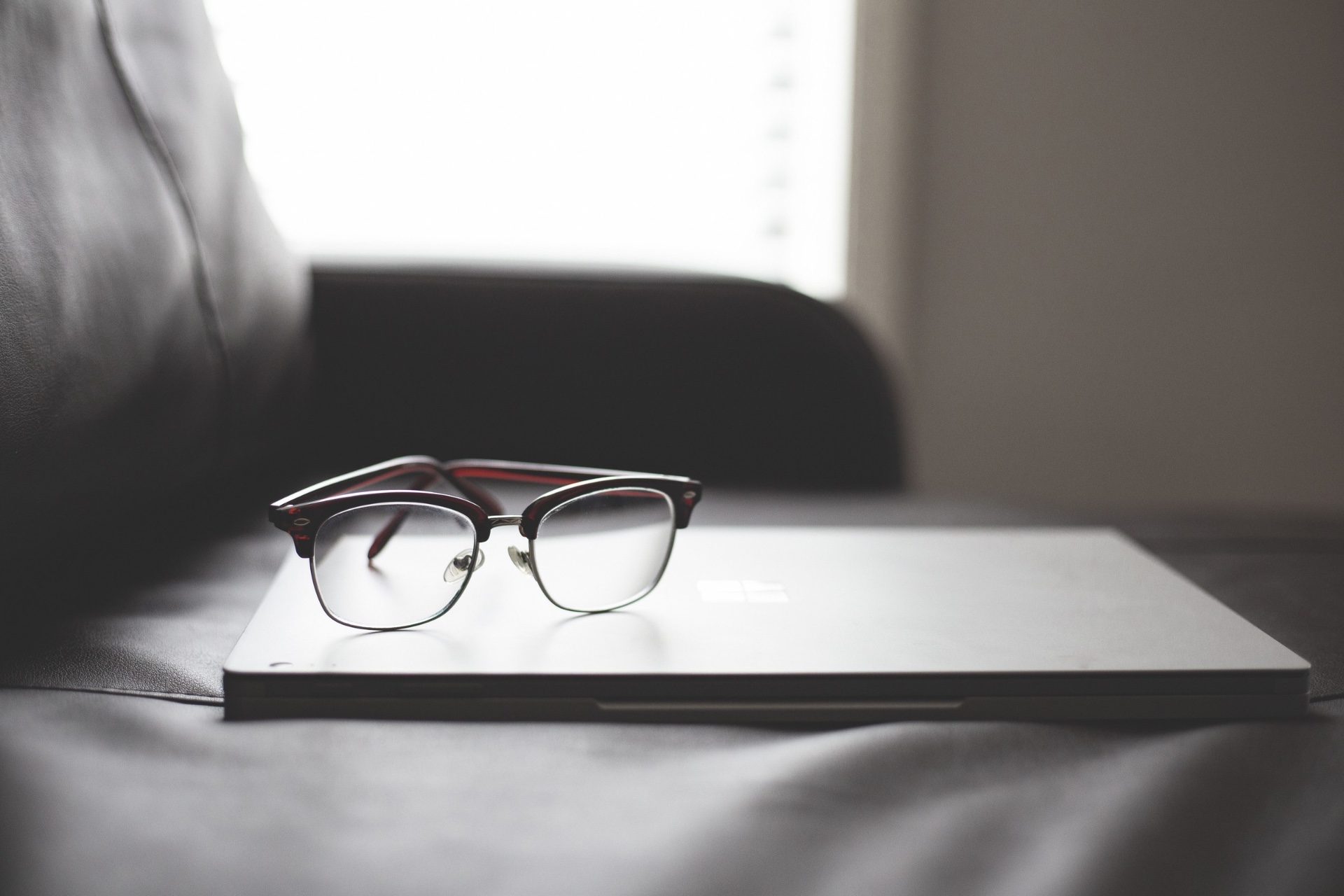 Still life with glasses on a laptop in window light