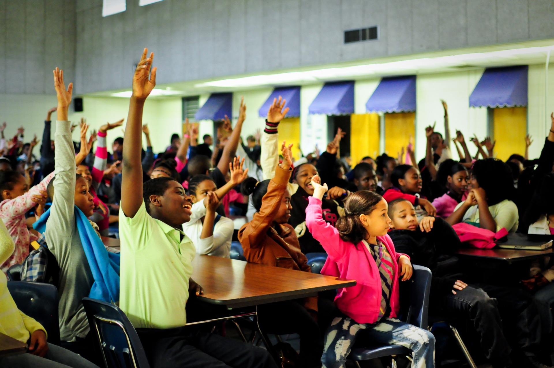 Hands raised in the crowd at a community gathering