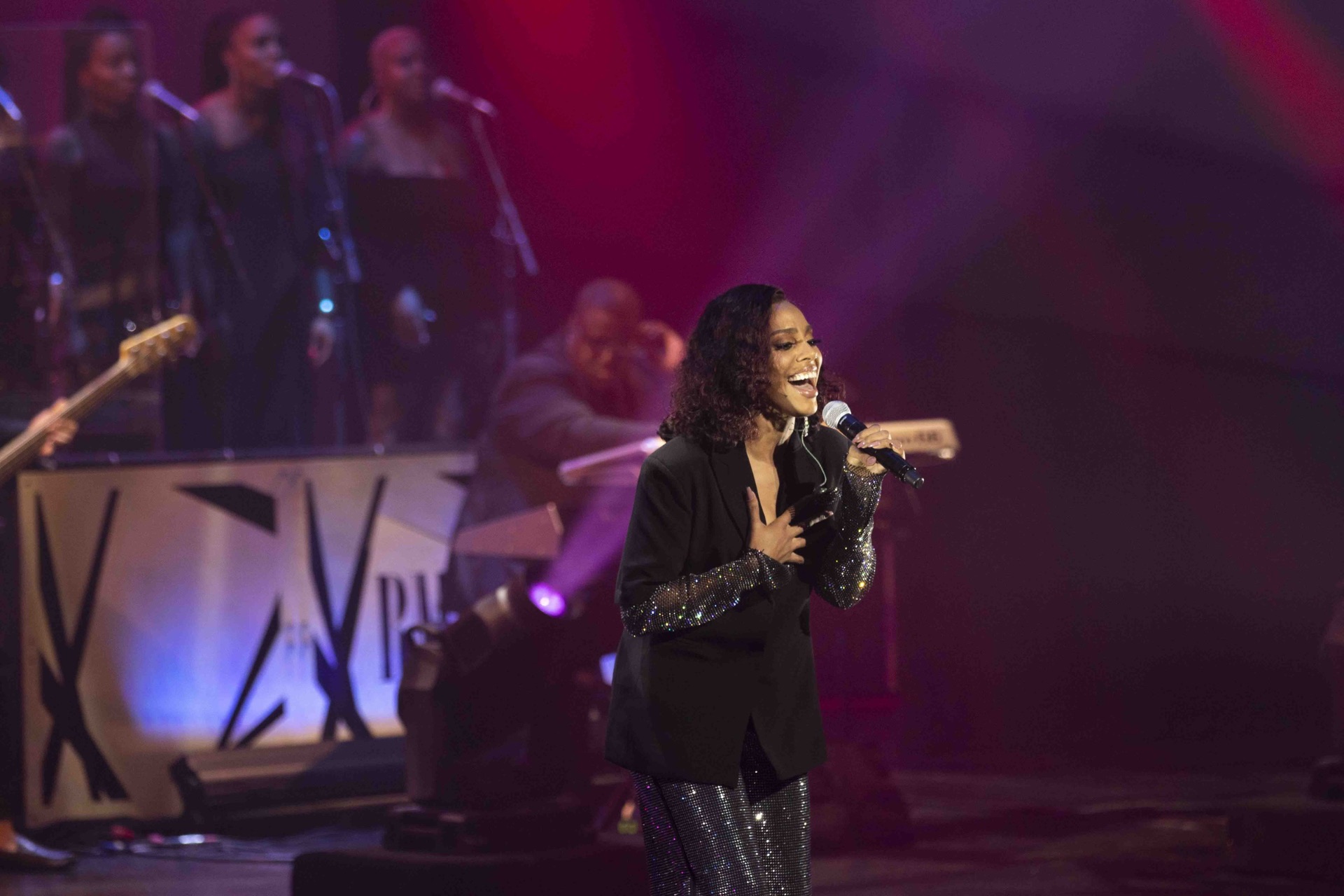 Vocalist mid-performance on the awards stage